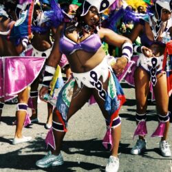 Dancers in colorful Carnival feathered costumes