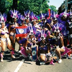 Carnival performers in purple feathered costumes