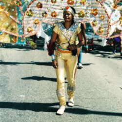 Parade performer in gold costume with headdress