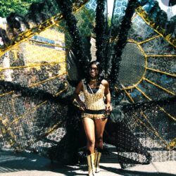 Carnival performer with large black and gold wings