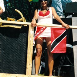 Smiling woman holding Trinidad and Tobago flag