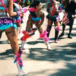 Colorful dancers in feathered parade costumes