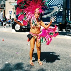 Carnival dancer in vibrant pink feathered costume