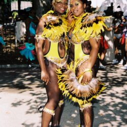 Two women in yellow feathered carnival costumes