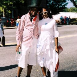 Smiling couple wearing costumes at street parade