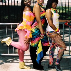 Three women wearing colorful carnival outfits