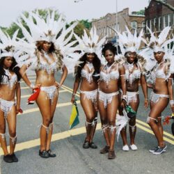 Six women in white feathered carnival parade costumes