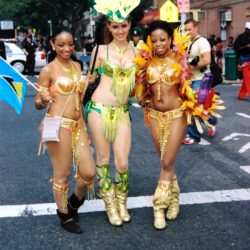 Three women in colorful carnival costumes