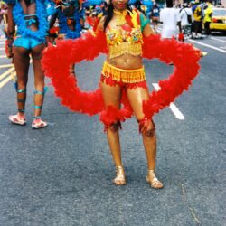 Red-feathered carnival dancer at street parade