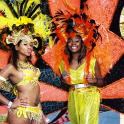 Two women in yellow feathered carnival costumes