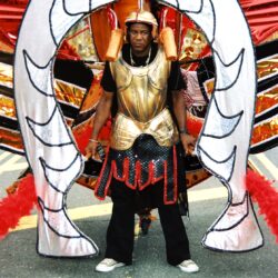 Carnival performer in ornate gold and red costume