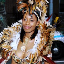 Smiling woman in elaborate feathered carnival costume