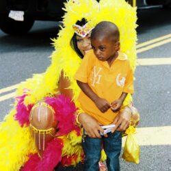 Young boy with woman in yellow carnival costume