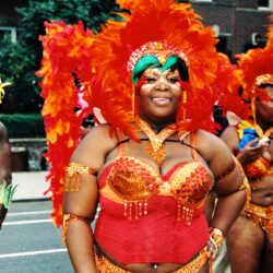 Woman in orange feathered carnival costume