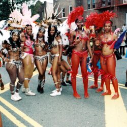 Women in colorful carnival costumes on street