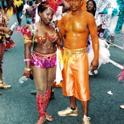 Couple in vibrant carnival costumes on street