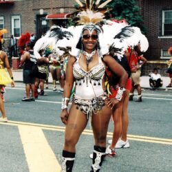 Carnival dancer in elaborate feathered street-parade costume