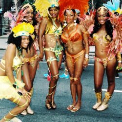 Women in bright feathered carnival parade costumes