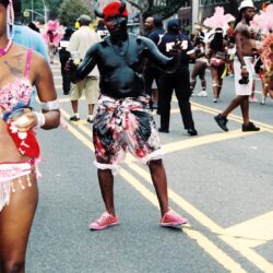 Person in body paint dancing at street carnival