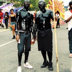 Two men in black body paint at parade