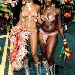Two women smiling in colorful carnival costumes
