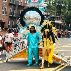 Parade couple in turquoise and yellow costumes