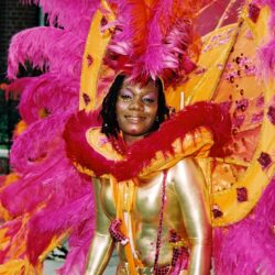 Woman in vibrant pink and orange carnival costume