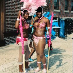 Two dancers in pink feathered carnival costumes