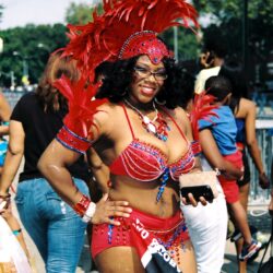Smiling woman in red feathered carnival costume