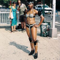 Carnival performer in feathered, bejeweled costume