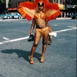 Woman in orange feathered carnival costume