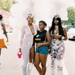 Three women in feathered carnival costumes