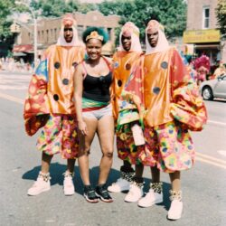 Group posing in colorful parade costumes
