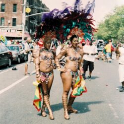 Two women in feathered carnival parade costumes