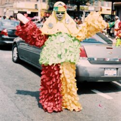 Performer in multicolored ruffled parade costume