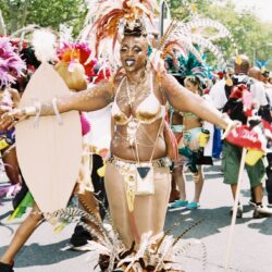 Dancer in feathered carnival costume at parade
