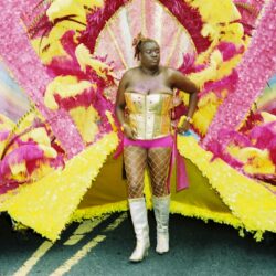 Carnival performer in pink and yellow costume