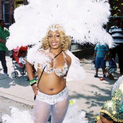 Smiling woman in white feathered carnival costume