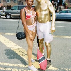 Woman in pink lingerie with gold-painted man