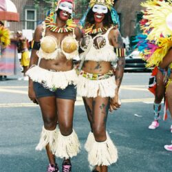 Two masked dancers in vibrant carnival costumes