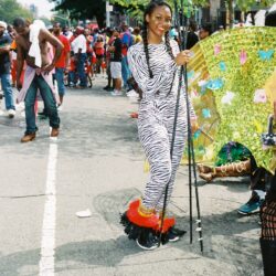 Smiling woman in zebra costume at parade