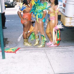 Three women in colorful carnival costumes