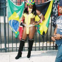 Woman in yellow carnival costume with Brazilian flags