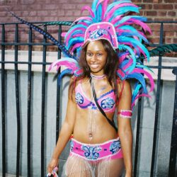 Smiling woman wearing pink and blue carnival costume