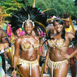 Two women in gold feathered carnival costumes