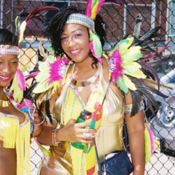 Woman in colorful feathered carnival costume smiling
