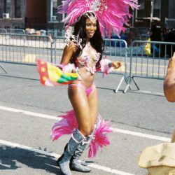 Woman in pink feathered carnival costume at parade