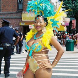 Smiling woman in blue and yellow carnival costume