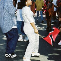 Woman in white dancing, waving red flag