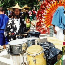 Parade musician playing drums in colorful costume